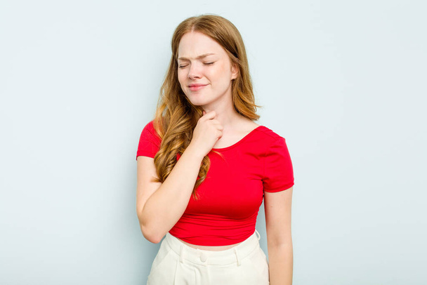Young caucasian woman isolated on blue background suffers pain in throat due a virus or infection. - Фото, изображение