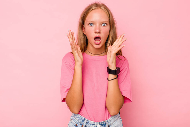 Caucasian teen girl isolated on pink background surprised and shocked. - Foto, Bild