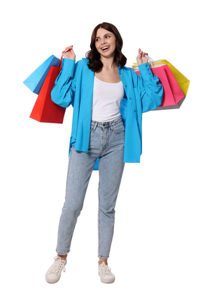 Beautiful young woman with paper shopping bags on white background - Foto, afbeelding