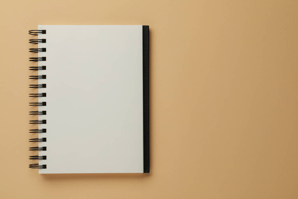 Blank notebook on beige background, top view. Space for text - Fotó, kép