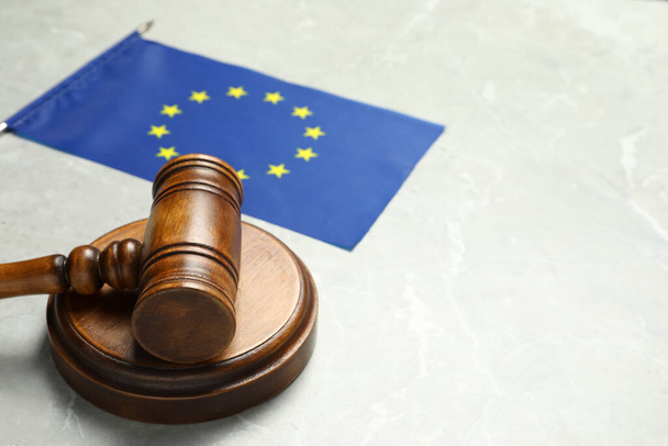 Judge's gavel and flag of European Union on light grey marble table. Space for text - Photo, Image