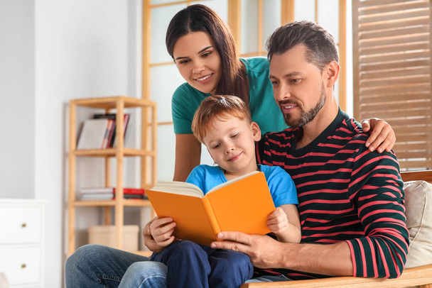 Happy family reading book together at home - Foto, imagen
