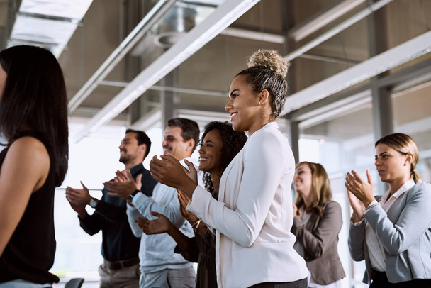 Nothing says powerful presentation like a standing ovation. a group of businesspeople clapping during a conference - Foto, imagen