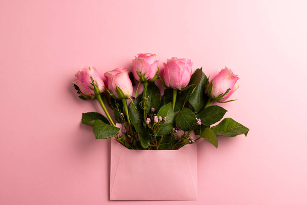 Composition of roses on pink background. Valentines day, celebration and copy space, digital composite image. - Fotoğraf, Görsel