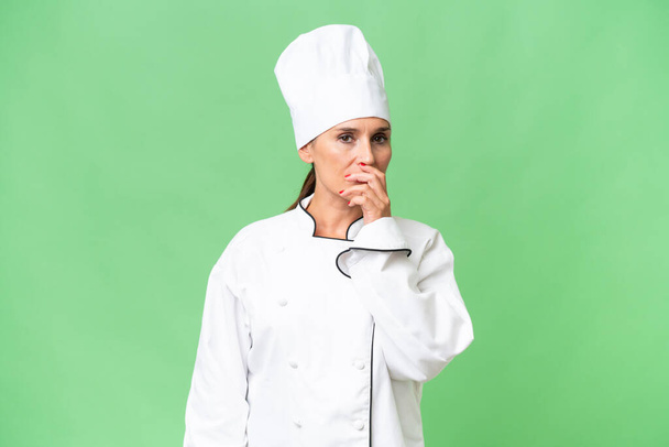 Middle-aged chef woman over isolated background having doubts and with confuse face expression - Photo, Image