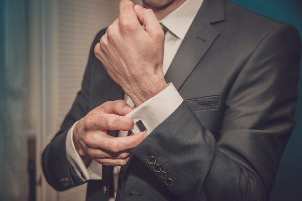 groom clasps cuff links on a shirt sleeve close up - Photo, Image