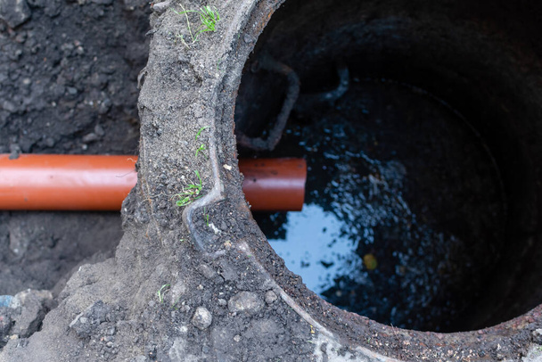 Repair of sewer drain with strong plastic pipe of large diameter in open area - Photo, Image