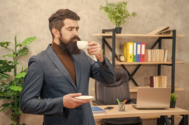 brutal ceo in businesslike suit enjoy morning coffee cup at the office, business. - Foto, Imagen
