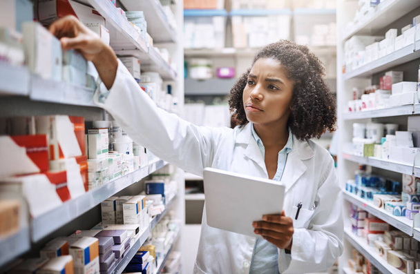 Shell find you the best medicine available. an attractive young female pharmacist working in a pharmacy - 写真・画像