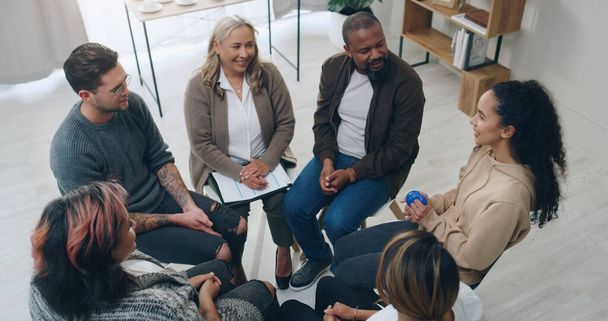 Team building, therapy group and people in circle for mental health support, communication and counseling service in office. Diversity, community and trust group of people in psychology talk together. - Photo, Image
