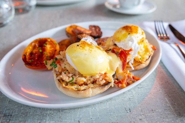 Lobster Benedict Served with Roasted Potatoes and Tomatoes - Photo, Image