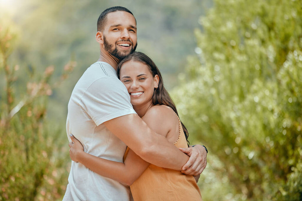 Black couple, hug and smile in woods together, outdoor and bush with love, romance or bonding on vacation in nature. Happy, man and woman embrace in portrait, forest or trees for happiness. - Fotografie, Obrázek