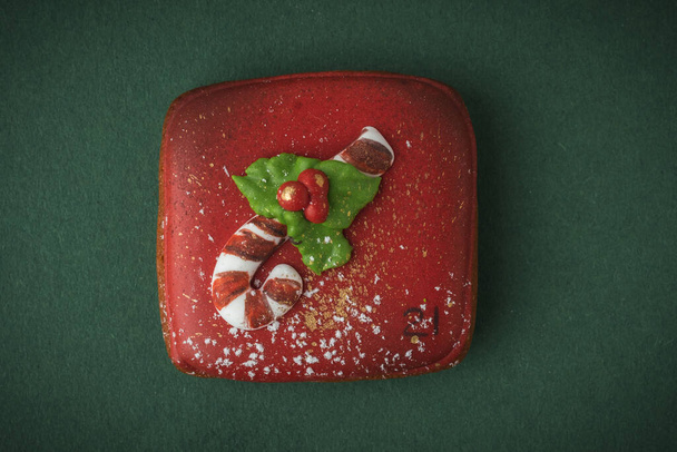 Delicious Christmas cookie from Advent calendar to count the days in anticipation of Christmas. Gingerbread cookie with festive icing on the green background. Merry Christmas and Happy New Year - Photo, Image