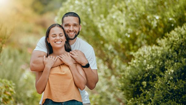 Love, happy and portrait with couple in park for for summer, hug and relax date together. Smile, nature and spring with man and woman in relationship in outdoor for peace, forest and calm lifestyle. - Foto, Imagen