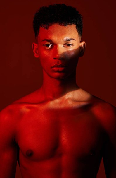 Beauty, body and aesthetic of young man in studio with neon red light for skincare, exercise or fitness background. Portrait of male commitment to exercise, health and body wellness for inspiration. - Foto, Imagem