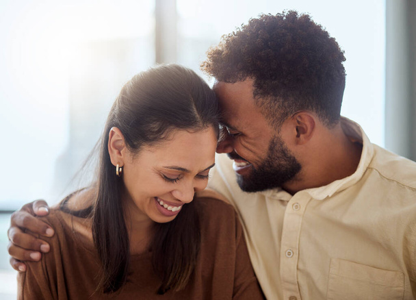 Couple, black people and love hug of a girlfriend and boyfriend with a smile together. Anniversary of happiness of a woman and man in a home laughing at a funny joke with happy bonding and affection. - Photo, Image