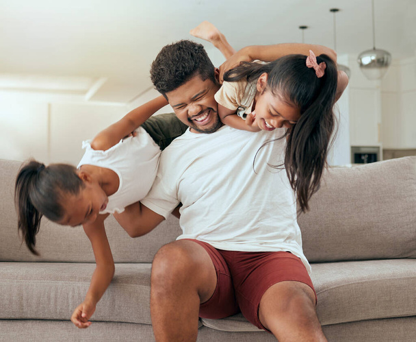 Happy, father and girl children with fun family time in a home living room sofa with a smile. Kids play, dad and children happiness of people on a lounge house sofa bonding in a black family home. - Foto, Imagem