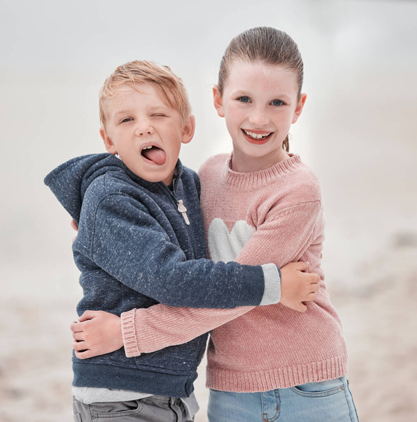 Smile, brother and sister with hug, happy and embrace being cheerful, fun and laugh together on summer break. Portrait, siblings or content being silly, goofy or outdoor for play, joyful or happiness. - 写真・画像