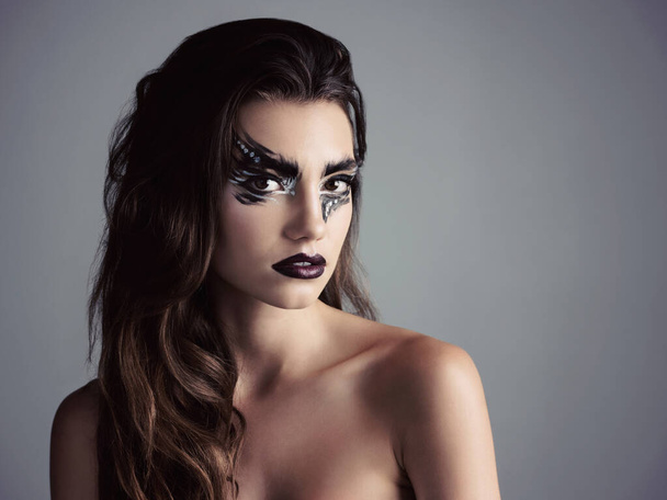 Size up your eyes. Studio shot of an attractive young woman wearing bold makeup - Foto, Imagem