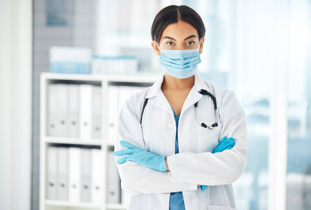 Covid, medical and arms crossed with portrait of doctor with face mask for medicine, help and insurance in hospital. Consulting, pandemic and healthcare with woman in clinic fo surgery and innovation. - Foto, Imagem