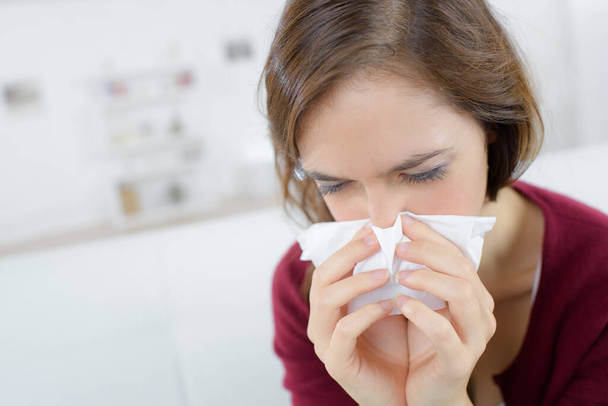 cold woman holding handkerchieif blowing nose - Photo, image