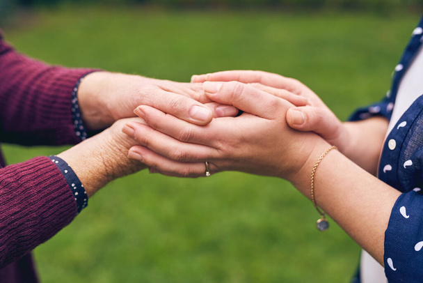 Family unites us. Closeup shot of unrecognizable women holding hands outside - Zdjęcie, obraz