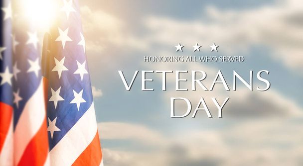 American flags with Text Veterans Day Honoring All Who Served on sunset background. American holiday banner. High quality photo - Photo, Image