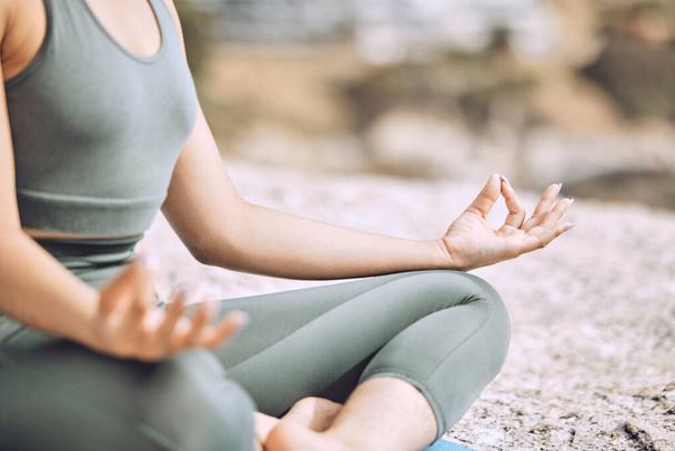 Woman, mudra hands and beach meditation for mental health, chakra balance or mind wellness. Zoom, zen or calm yogi in lotus pose, peace or holistic energy mindset training in nature earth environment. - Photo, image