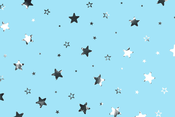 Silver stars and sparkles on the blue background. Festive or party backdrop. - Photo, Image