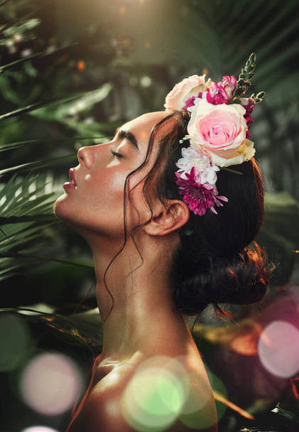 Rainforest, skincare and beauty girl with flower accessory crown for tropical cosmetic with bokeh profile. Natural, jungle and wellness model woman with roses for floral cosmetics advertising - Foto, imagen