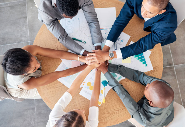 Hands, teamwork and motivation with a business team sitting at a table in a boardroom from above. Collaboration, meeting and unity with an employee group working on finance or accounting documents. - Foto, Imagem
