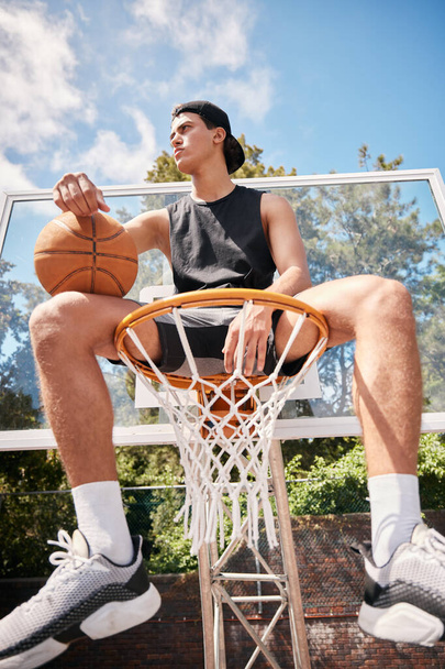 Basketball, sports and man on basket with ball for fitness, exercise and training workout at a community park with sports sneakers. Basketball player, urban court and game with male athlete thinking. - Foto, imagen