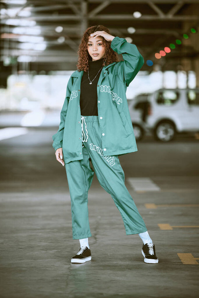 Urban, fashion and girl portrait at parking lot in New York with edgy athleisure style. Gen Z, trendy and statement clothes of young city woman with assertive, confident and cool pose - Photo, image