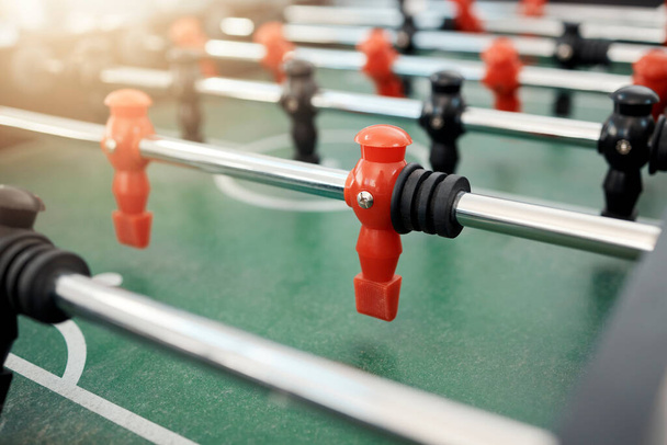 Foosball, game and table for entertainment, fun and team activity with artificial toy or players in zoom. Plastic, arcade and games for competition, competitive and miniature football or soccer field. - Foto, Imagem
