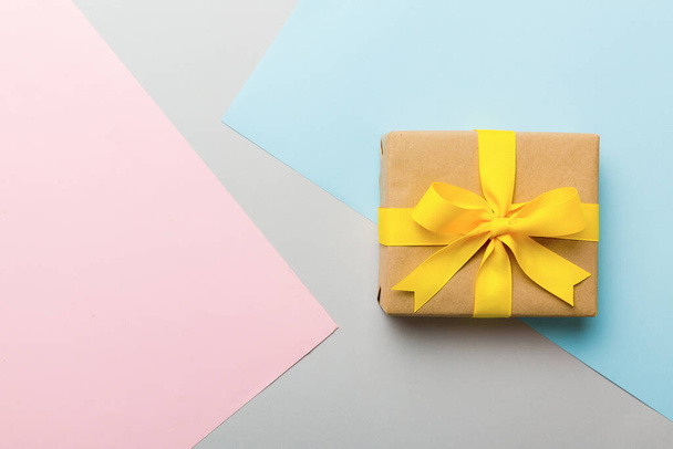 holiday paper present tied yellow ribbon bow top view with copy space. Flat lay holiday background. Birthday or christmas present. Christmas gift box concept with copy space. - Foto, Imagen
