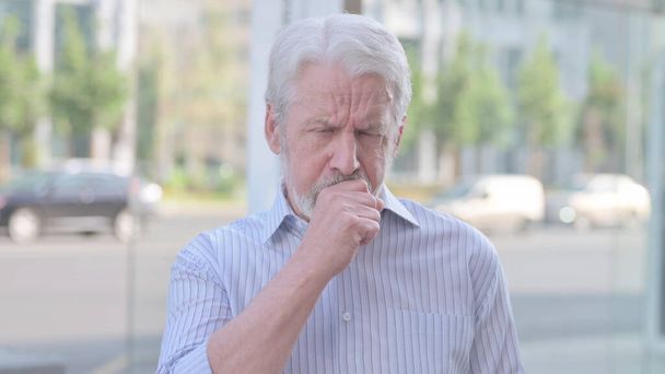 Senior Old Man Coughing while Standing Outdoor - Photo, image