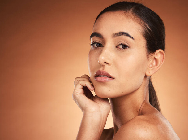 Beauty, makeup and face portrait of woman on brown studio background. Wellness, aesthetic and skincare routine of young female model from Australia with luxury cosmetics, smooth skin or glowing skin. - 写真・画像