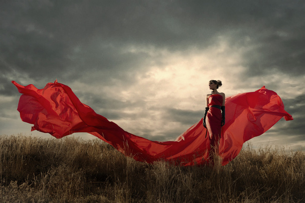Woman in red dress waving on wind. Looking down. - Photo, image