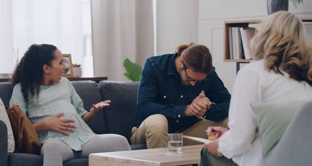 Pregnant woman, man and fight with psychologist, counseling and mental health argue about problem. Couple, stress in support therapy in psychology office to discuss mistake, fail and marriage divorce. - 写真・画像