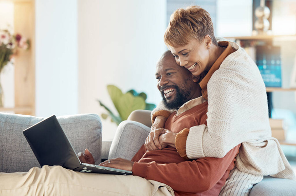 Black couple, laptop and hug together with technology at home, watching a film or video call with 5g network. Black man, black woman and spending quality time on sofa, connection and streaming online. - Фото, зображення