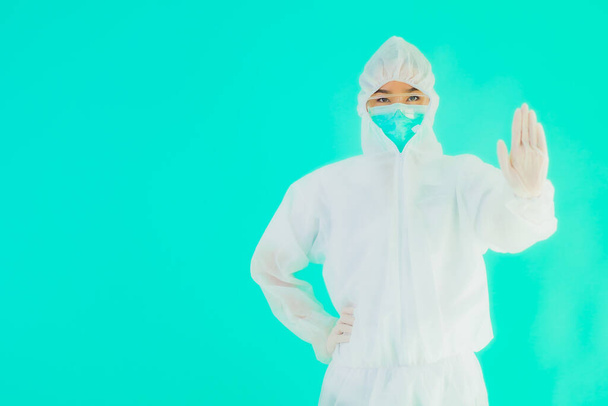 Portrait beautiful young asian doctor woman wear ppe or  personal protective equipment for protect from coronavirus or covid19 on blue isolated background - Photo, Image