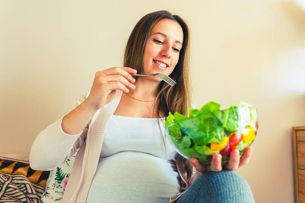 Pregnant woman eating healthy food. Happy pregnancy mother eating nutrition diet salad. Healthy breakfast food concept - Photo, image