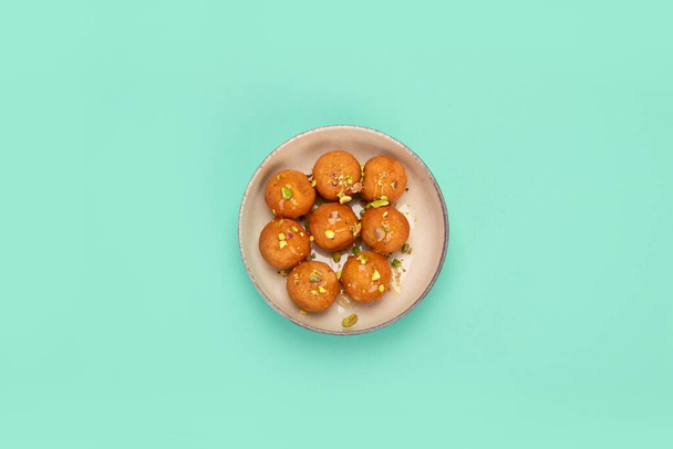 Greek Loukoumades on color background. Traditional food. Creative photo concept. Top view, copy space - Фото, изображение