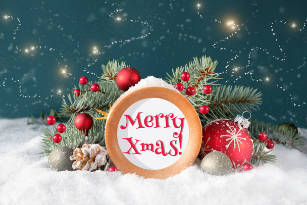 Merry Christmas text on round wooden frame with fir twigs, cones, red trinkets and berries. Dark blue background with snow and stars. Traditional Christmas, Xmas decor. - Фото, зображення