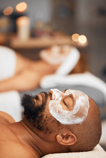 Spa facial, skincare and couple with face mask for luxury self care routine, glowing skin or wellness treatment. Beauty product, healthcare support and black woman and man relax with salon face cream. - Фото, изображение