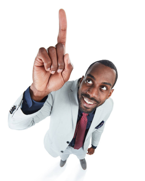 Its all the way up there. Studio shot of a young businessman pointing against a white background - Foto, immagini