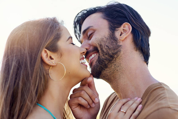 Целую вечно. улыбающаяся молодая пара обнимается и целуется, наслаждаясь днем вместе в парке - Фото, изображение