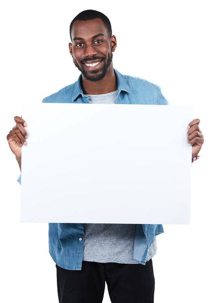 Right here. Cropped portrait of a young man holding an empty sign against a white background - Zdjęcie, obraz