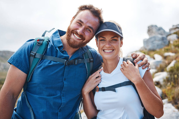 Hiking, fitness and love with a couple in the mountains for exercise, adventure or cardio during the day. Nature, health and training with a man and woman walking outdoor on a mountain trail together. - Фото, изображение