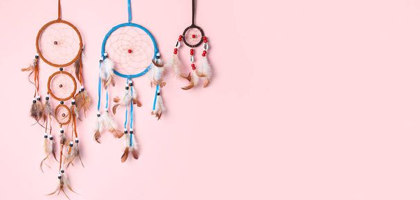 Beautiful dream catchers on pink background with space for text - Фото, зображення